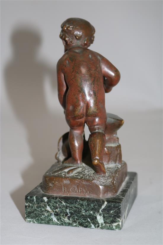 Henri Capy. A bronze figure of a putto forging an arrow, 6in.